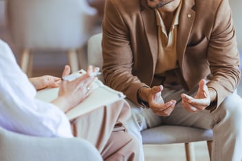 Professional Conversation Between Individuals in a Counseling Setting.